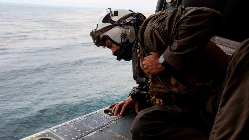 PHOTO: This US Marine Corps photo obtained Aug. 2, 2020 shows Naval Air Crewman  participating in search and rescue relief operations following an AAV-P7/A1 assault amphibious vehicle mishap off the coast of Southern California.