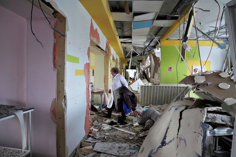 PHOTO: A medical worker walks through the hall of a maternity hospital damaged in a shelling attack in Mariupol, Ukraine, March 9, 2022.
