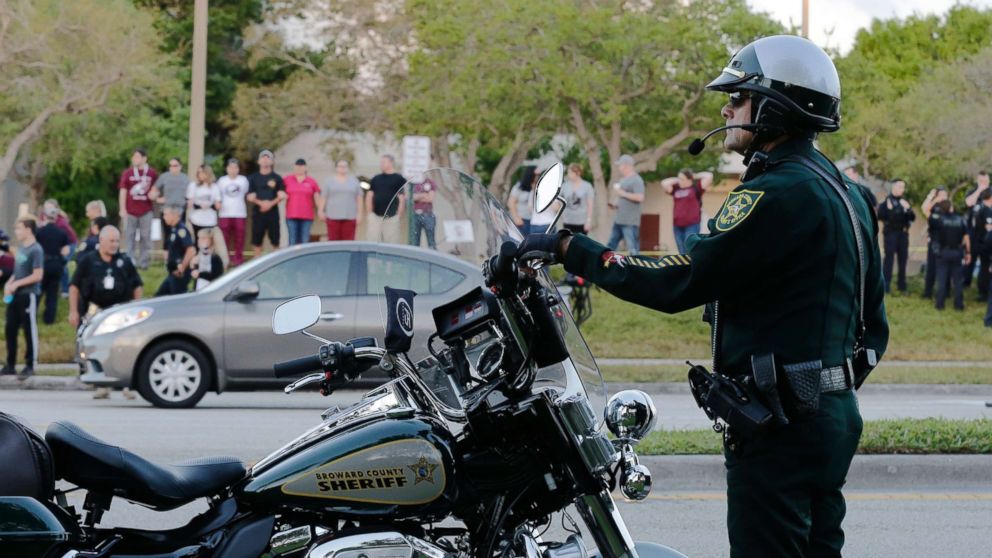 A police officer stands watch at Marjory Stoneman Douglas High School in Parkland, Fla., Feb. 28, 2018. Students returned to class for the first time since a former student opened fire there with an assault weapon.