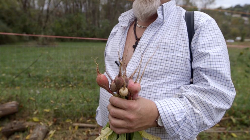 PHOTO: Mark Cafego shows off freshly-harvested vegetables from a community garden in Morgantown, West Virginia. He harvests the produce with the help of drug addiction recovery organization, Friendship House.