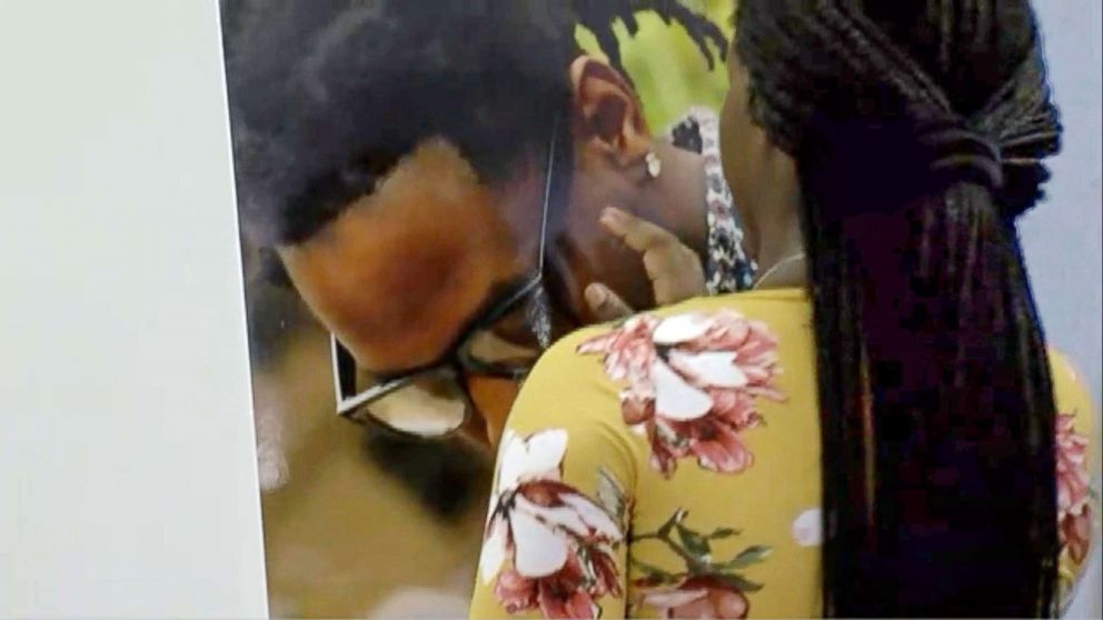   PHOTO: Britney Jacobs touches the photo of her boyfriend, Markeis McGlockton, at a press conference on July 24, 2018 in Clearwater, Florida. 