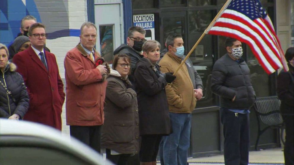 PHOTO: People watch a procession in honor of Bradley Police Sergeant Marlene Rittmanic, who was killed in the line of duty, in Kankakee, Ill., Dec. 30, 2021.