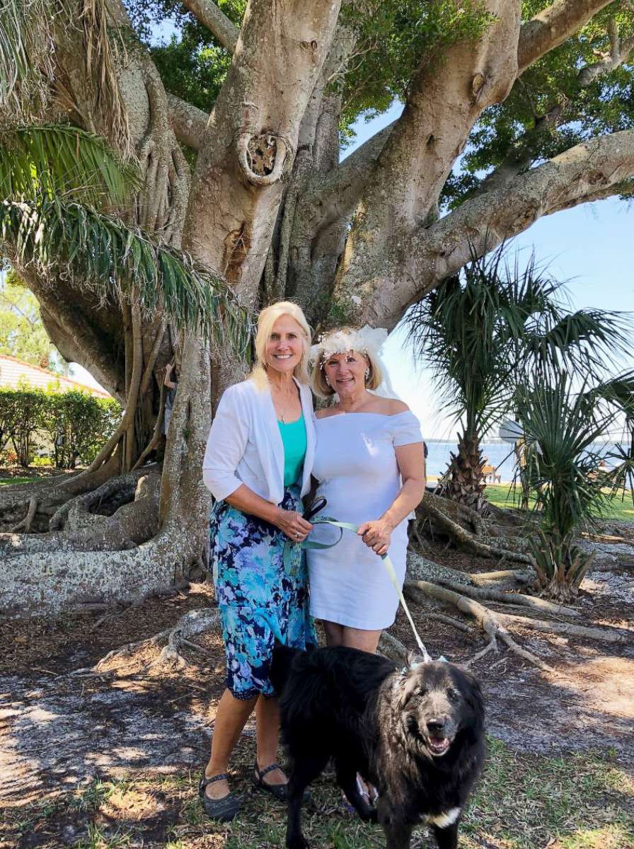 PHOTO: Bride Karen Cooper, who married tree, with her Maid of Honor, Ann Cason,left, and her canine ring bearer, Little Bear, in front of 100-year-old ficus tree in Snell Family Park in Fort Myers, Fla. on March 24, 2018. 
