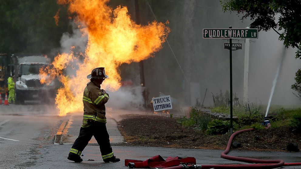 PHOTO: CCaptain Craig Robinson walks by Puddlewharf Lane while making sure the gas line fire near 326 Plain Street on Rt. 139 in Marshfield, Mass. is contained, May 29, 2021.