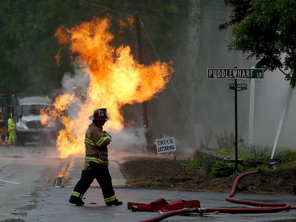 PHOTO: CCaptain Craig Robinson walks by Puddlewharf Lane while making sure the gas line fire near 326 Plain Street on Rt. 139 in Marshfield, Mass. is contained, May 29, 2021.