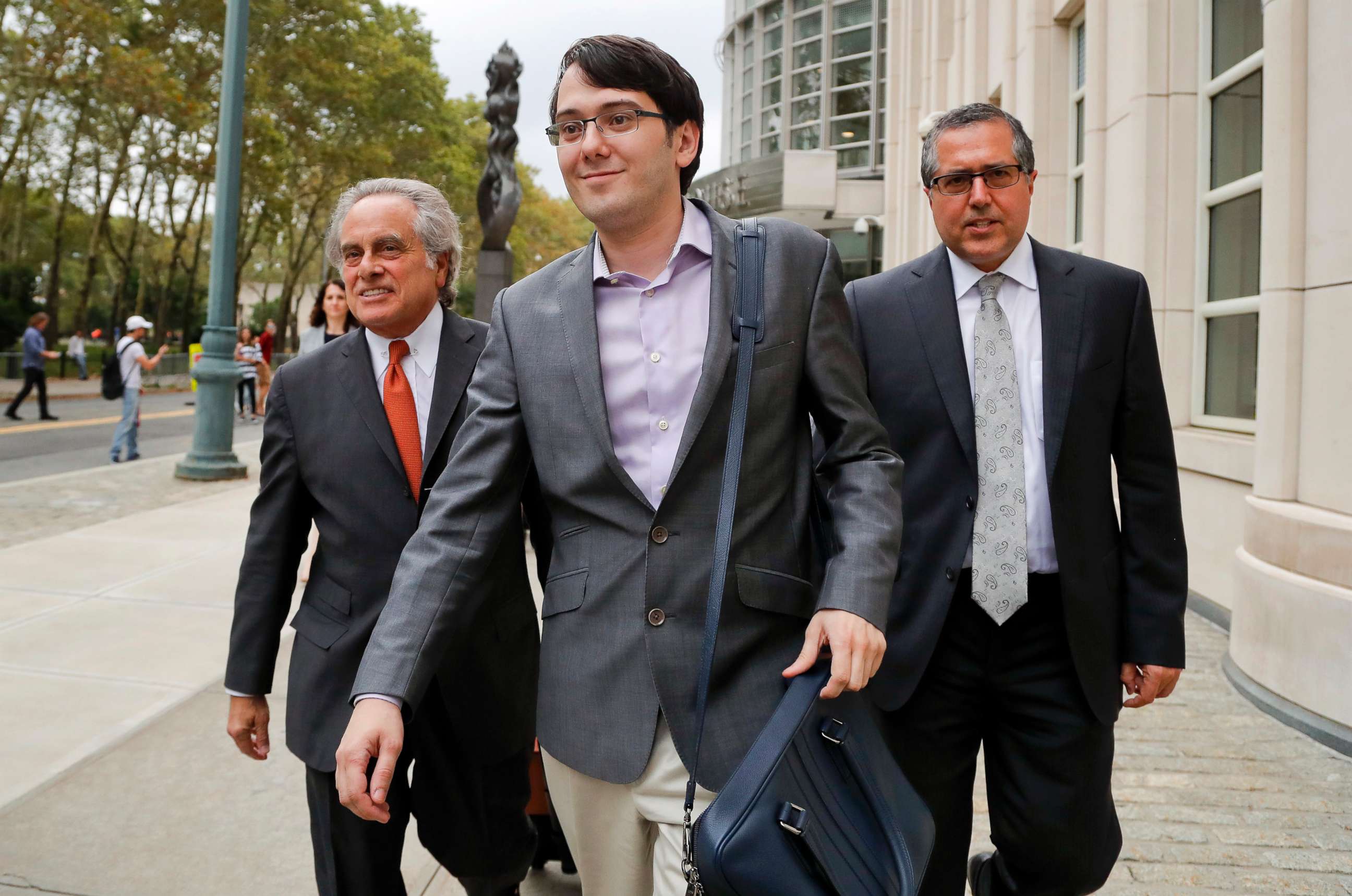 PHOTO: Former biotech CEO Martin Shkreli, center, leaves federal court with his attorney Benjamin Brafman, left, in New York, July 27, 2017.