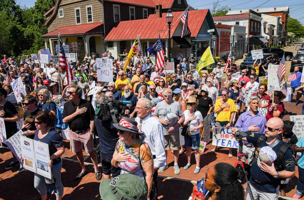 PHOTO: A group called "Reopen Maryland" say the pledge of allegiance as they gather to protest the restrictions imposed by Maryland Governor Larry Hogan to combat the spread of the novel coronavirus.