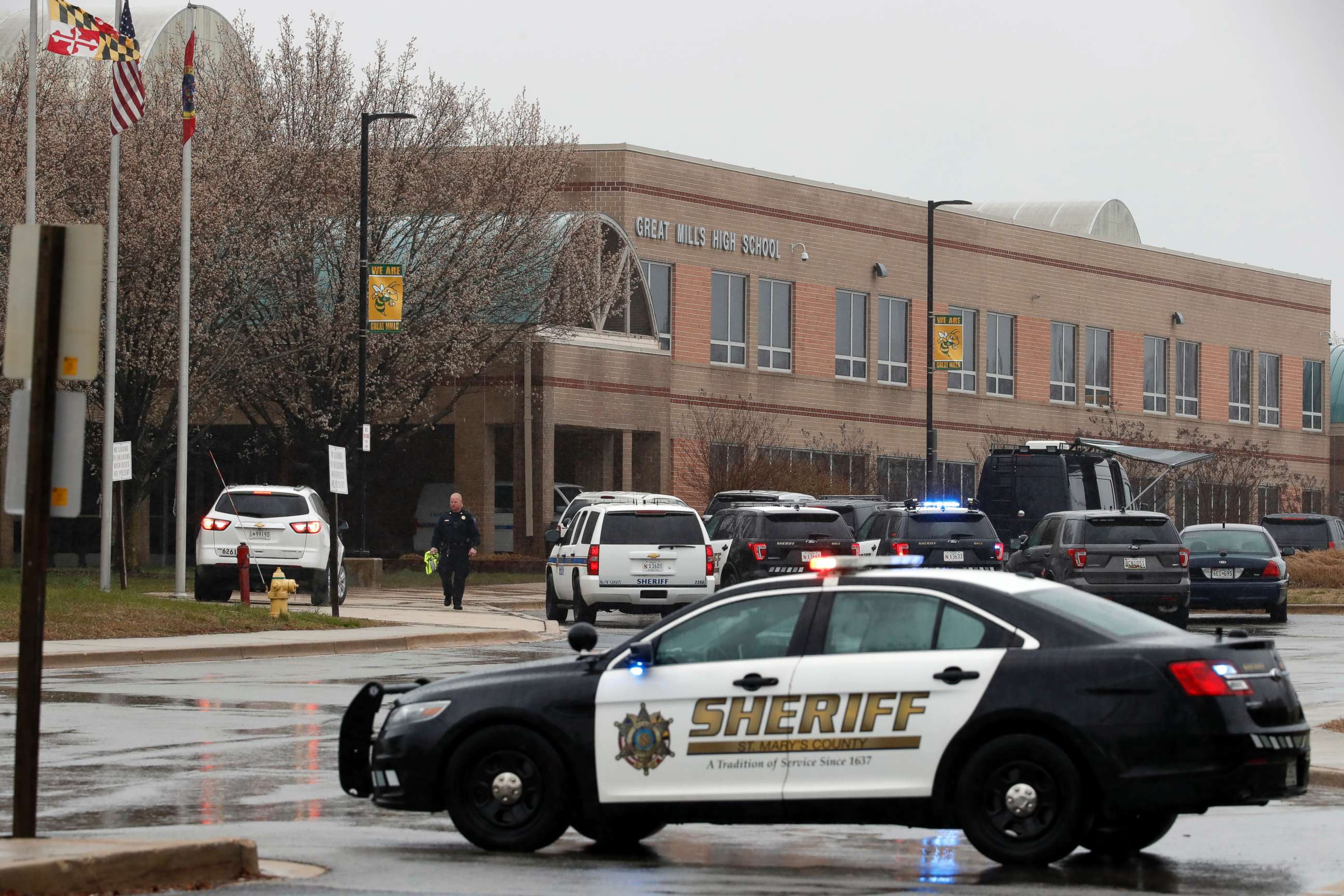 PHOTO: A law enforcement officer walks in front of Great Mills High School after a shooting on March 20, 2018, in Great Mills, Md.
