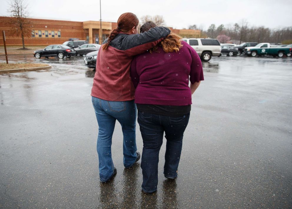 PHOTO: A mother walks her daughter, a student from Great Mills High School, to the car as she picks her up from Leonardtown High School in Leonardtown, Md., March 20, 2018.  