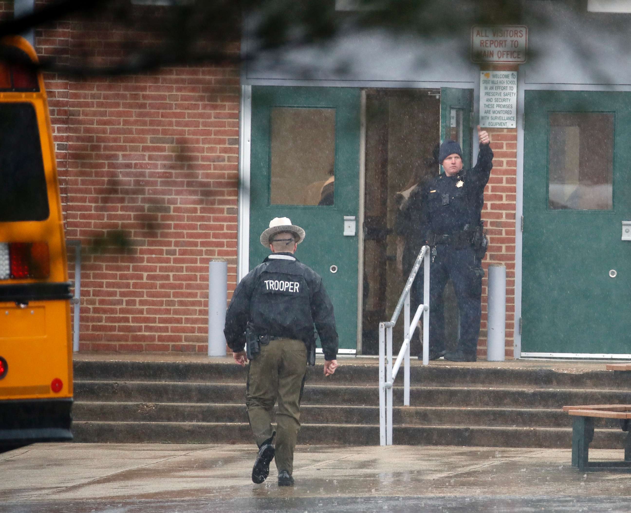 PHOTO: A policeman gives a thumbs-up after moving students into a different area of Great Mills High School, the scene of a shooting,  March 20, 2018 in Great Mills, Md. 