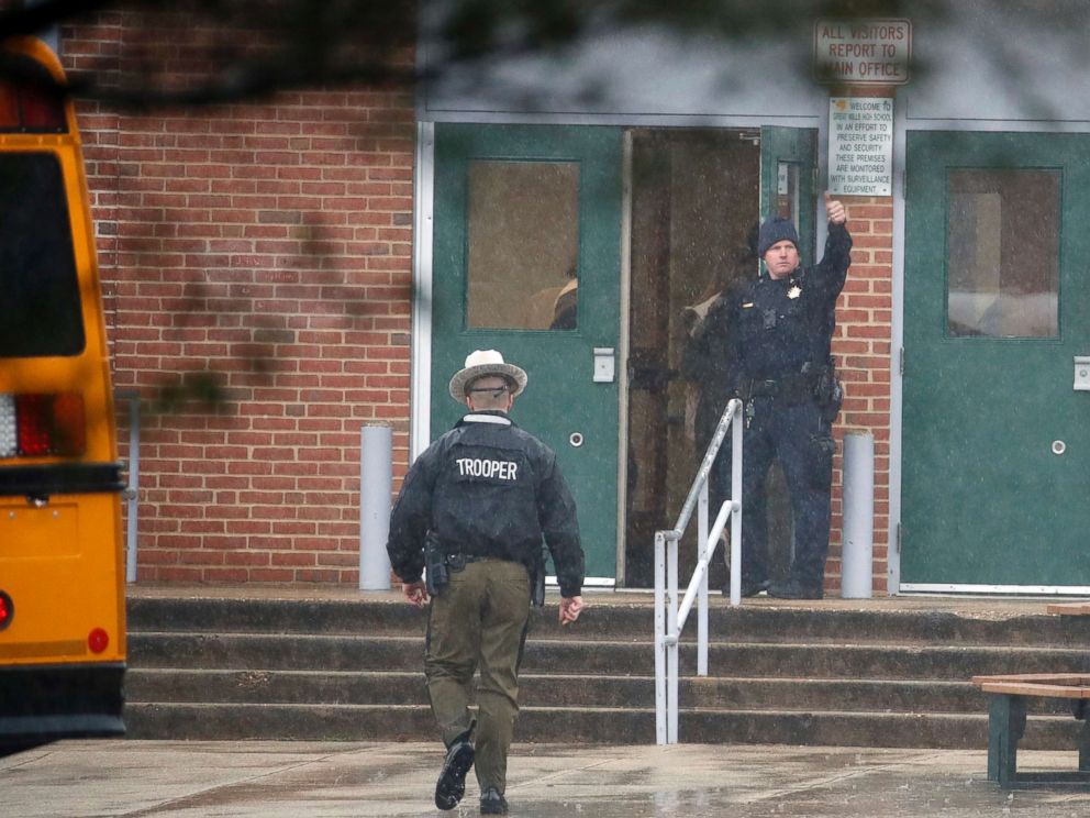 PHOTO: A policeman gives a thumbs-up after moving students into a different area of Great Mills High School, the scene of a shooting, March 20, 2018 in Great Mills, Md.