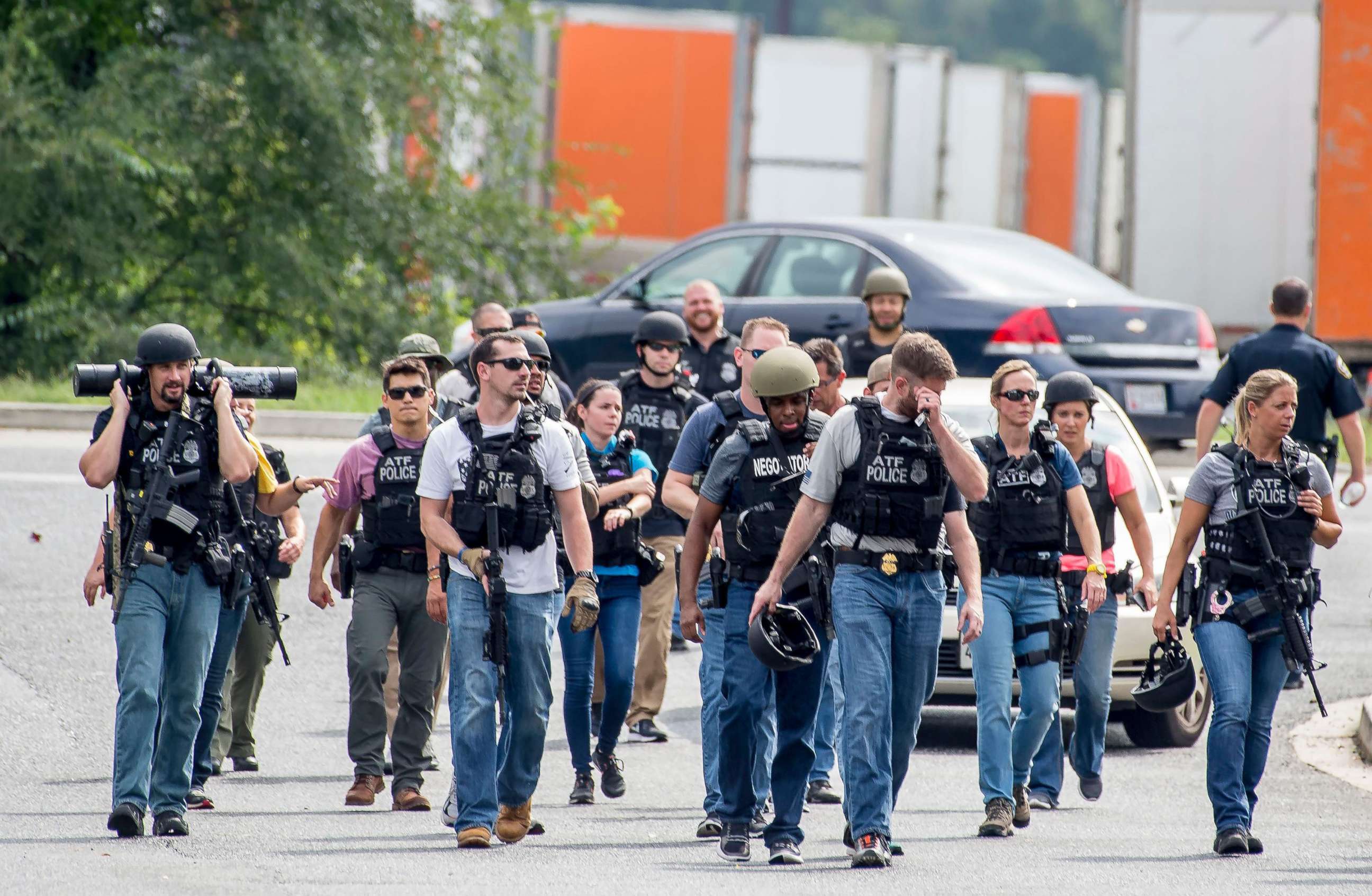 PHOTO: Agents on patrol after clearing an area near a warehouse as police search for a gunman who fled the scene of a shooting at a Rite Aid Distribution Center in Aberdeen, Maryland,Sept. 20, 2018.