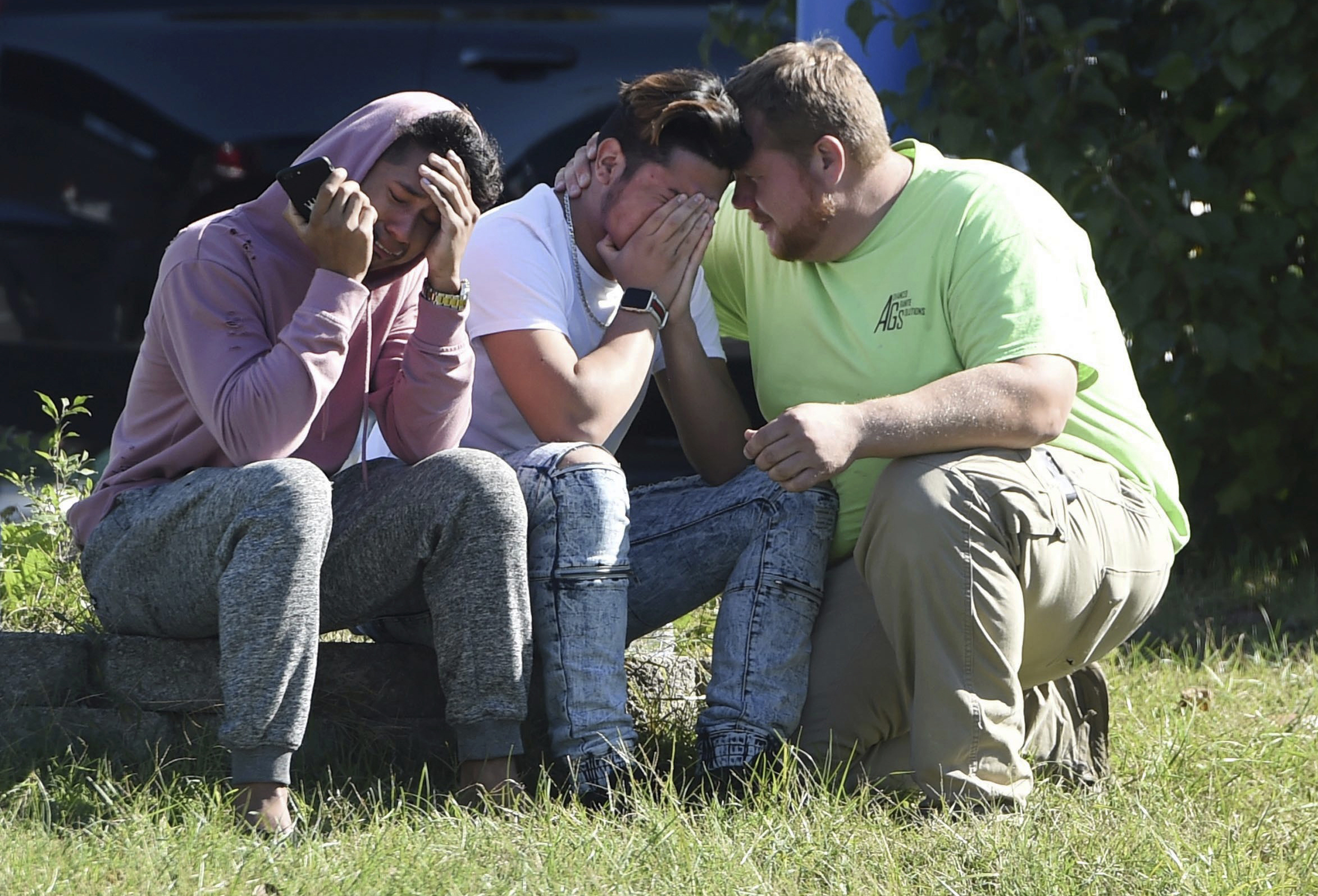 PHOTO: Workers from the Advanced Granite Solutions company console each other as police and Emergency Medical Services respond to a shooting at a business park in the Edgewood area of Harford County, Md., Oct. 18, 2017.