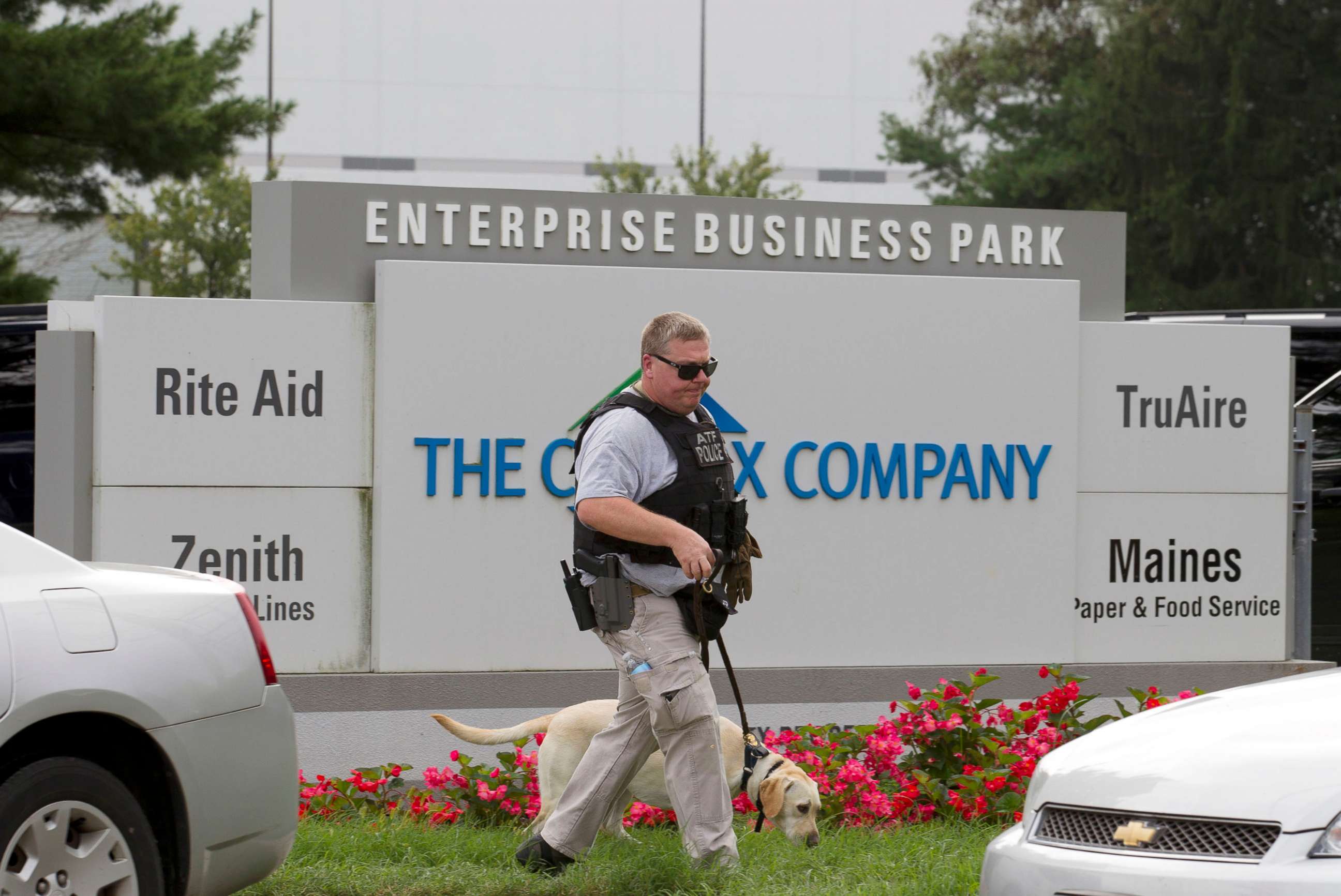PHOTO: ATF police officer with a sniffing dog walks out the industrial complex in Harford County, Md., Sept. 20, 2018.