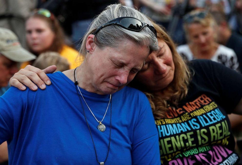 PHOTO: Community members Carol Geithner, left, and Yasemine Jamison take part in a candlelight vigil near the Capital Gazette, the day after a gunman killed five people inside the newspaper's building in Annapolis, Md., June 29, 2018.