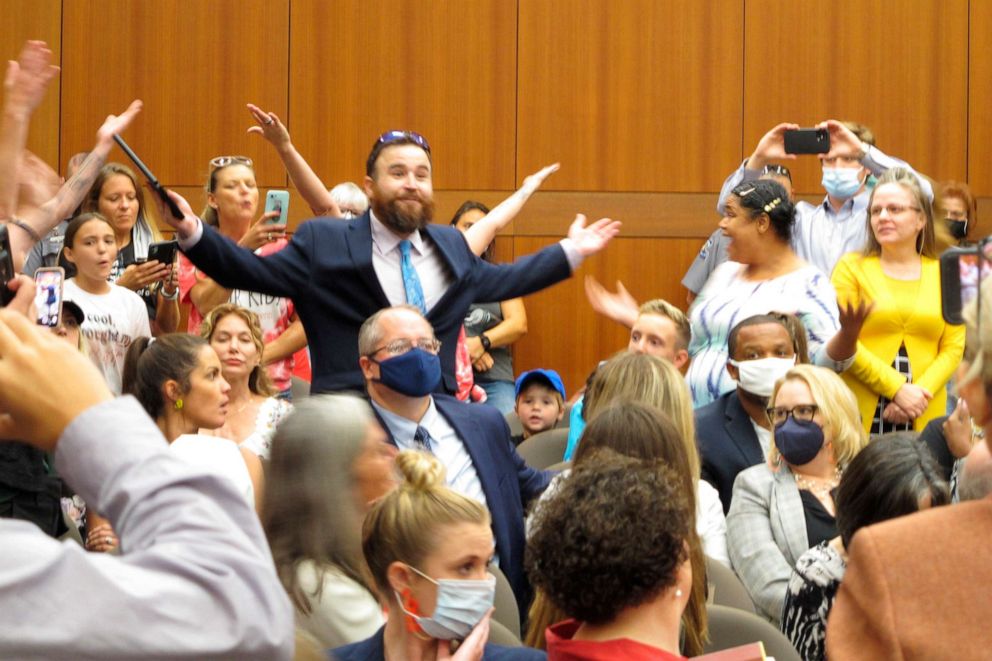 PHOTO: A crowd people objecting to Louisiana Gov. John Bel Edwards' mask mandate for schools shouts in opposition to wearing a face covering at the Board of Elementary and Secondary Education meeting, Aug. 18, 2021, in Baton Rouge, La.