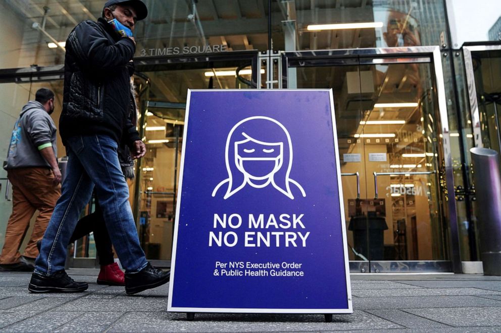 PHOTO: A "No Mask No Entry" sign is pictured outside a business in Times Square during the coronavirus disease (COVID-19) pandemic in New York City, Dec. 15, 2021.