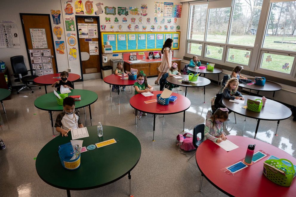 PHOTO: A teacher walks among the the masked students sitting in a socially distanced classroom session at Medora Elementary School on March 17, 2021, in Louisville, Ky.