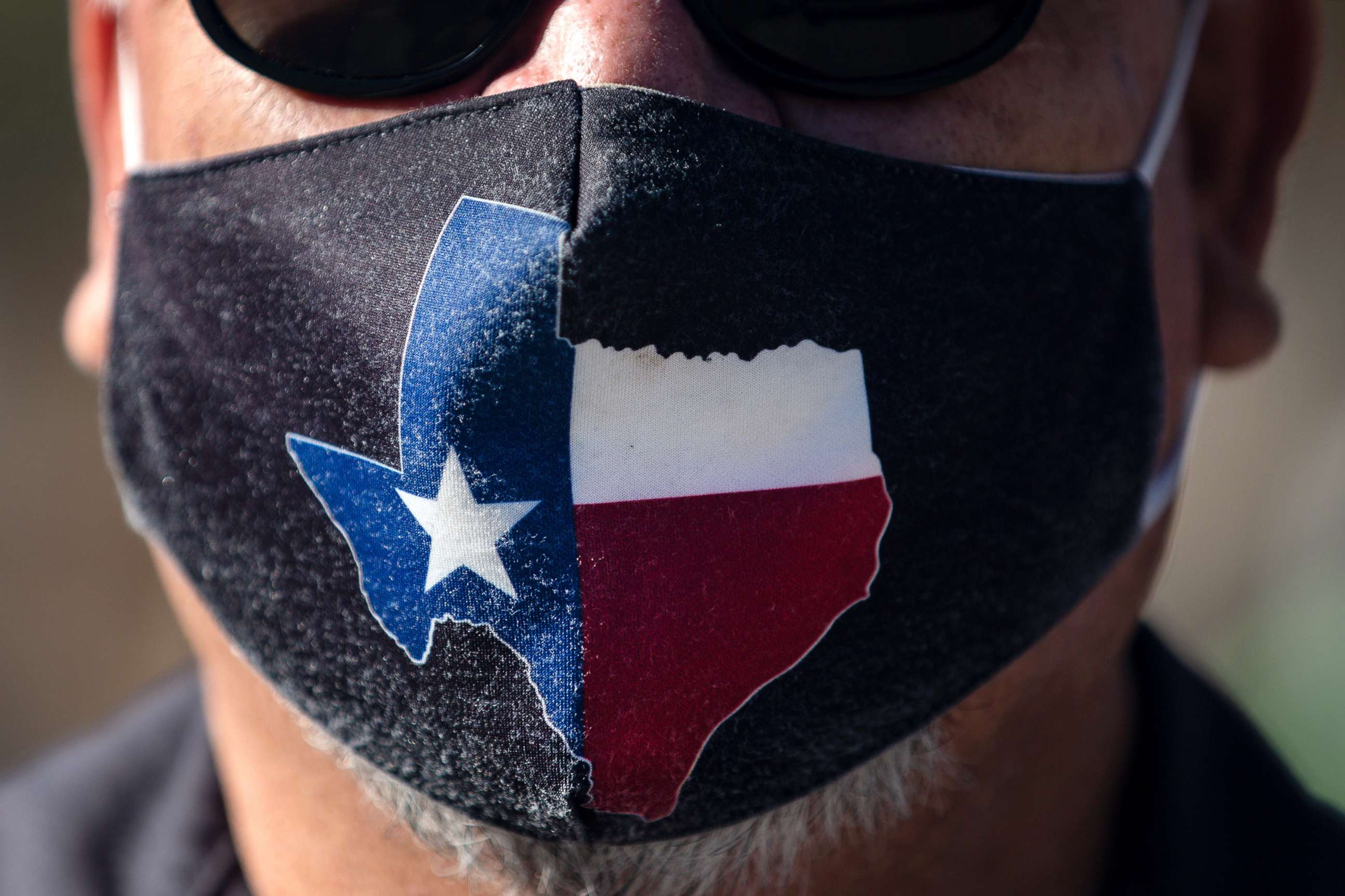 PHOTO: A man wears a Texas-themed mask on March 3, 2021 in Austin, Texas. Gov. Greg Abbott announced a new executive order that will end the statewide mask mandate and allow businesses to reopen at 100% capacity on March 10, 2021. 