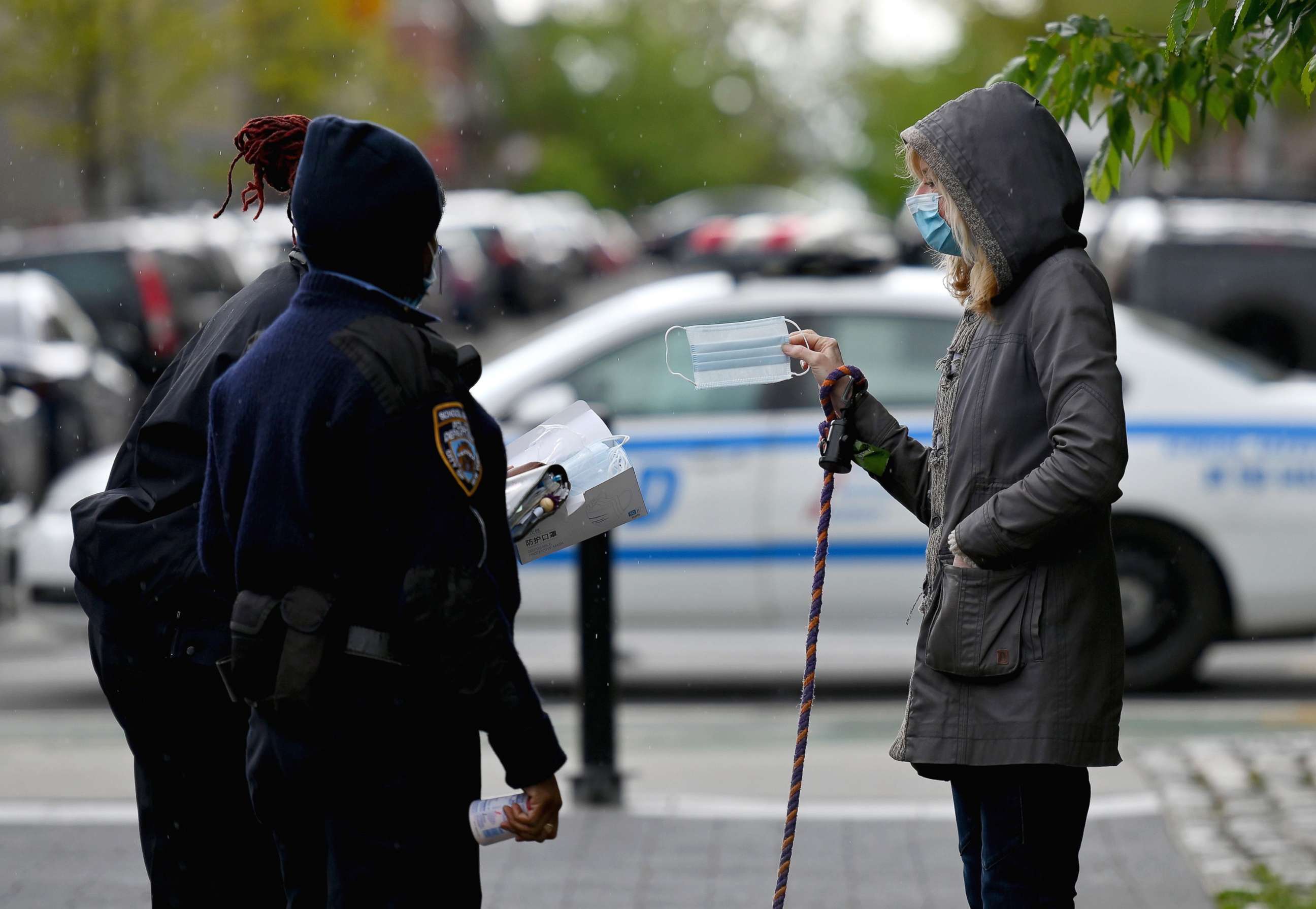 PHOTO: NYPD officers hand out free face masks on May 11, 2020 in the Brooklyn borough of New York City.