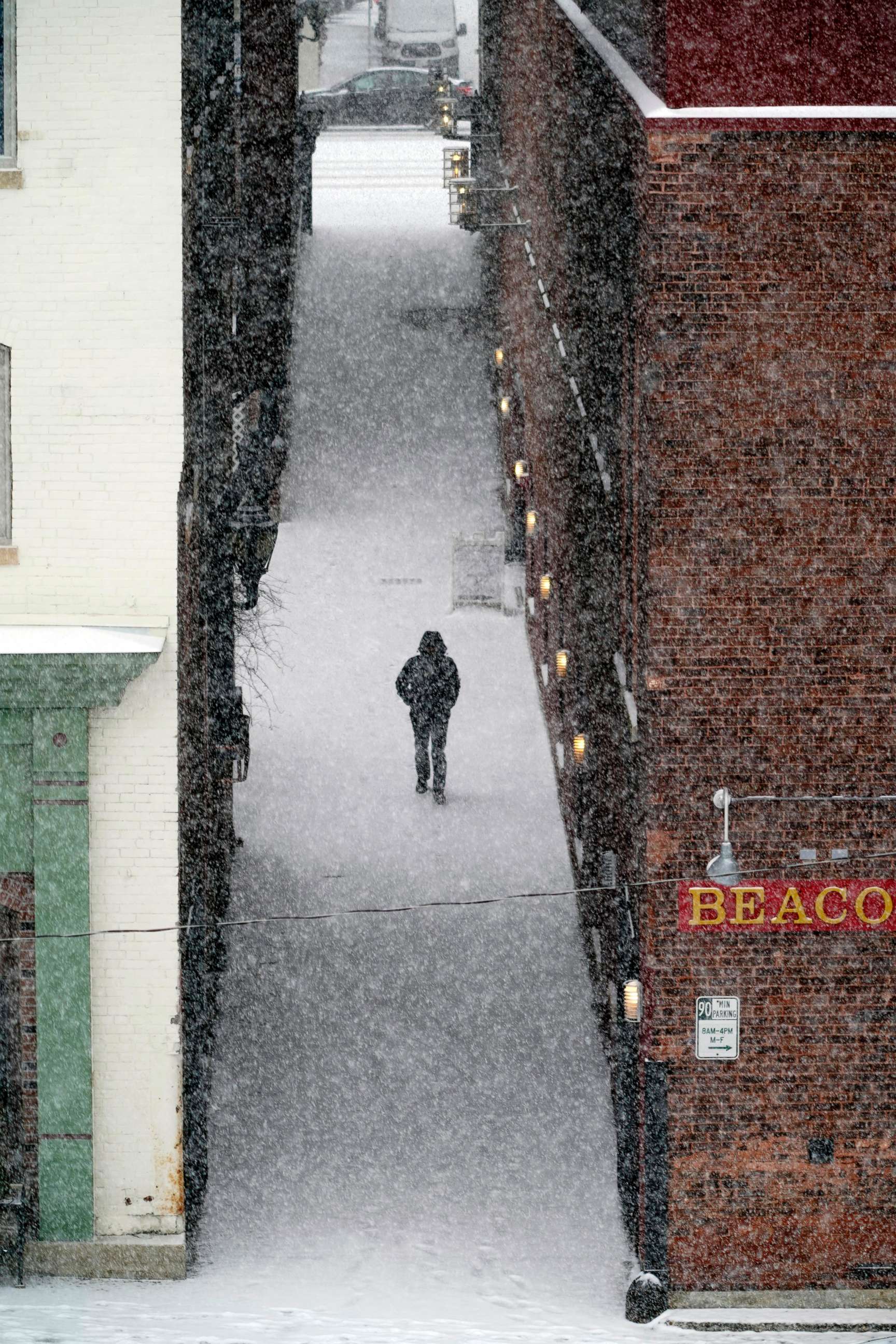 PHOTO: A man walks down an alley to McKay Street as snow falls in Pittsfield, Mass., Feb, 12, 2019.