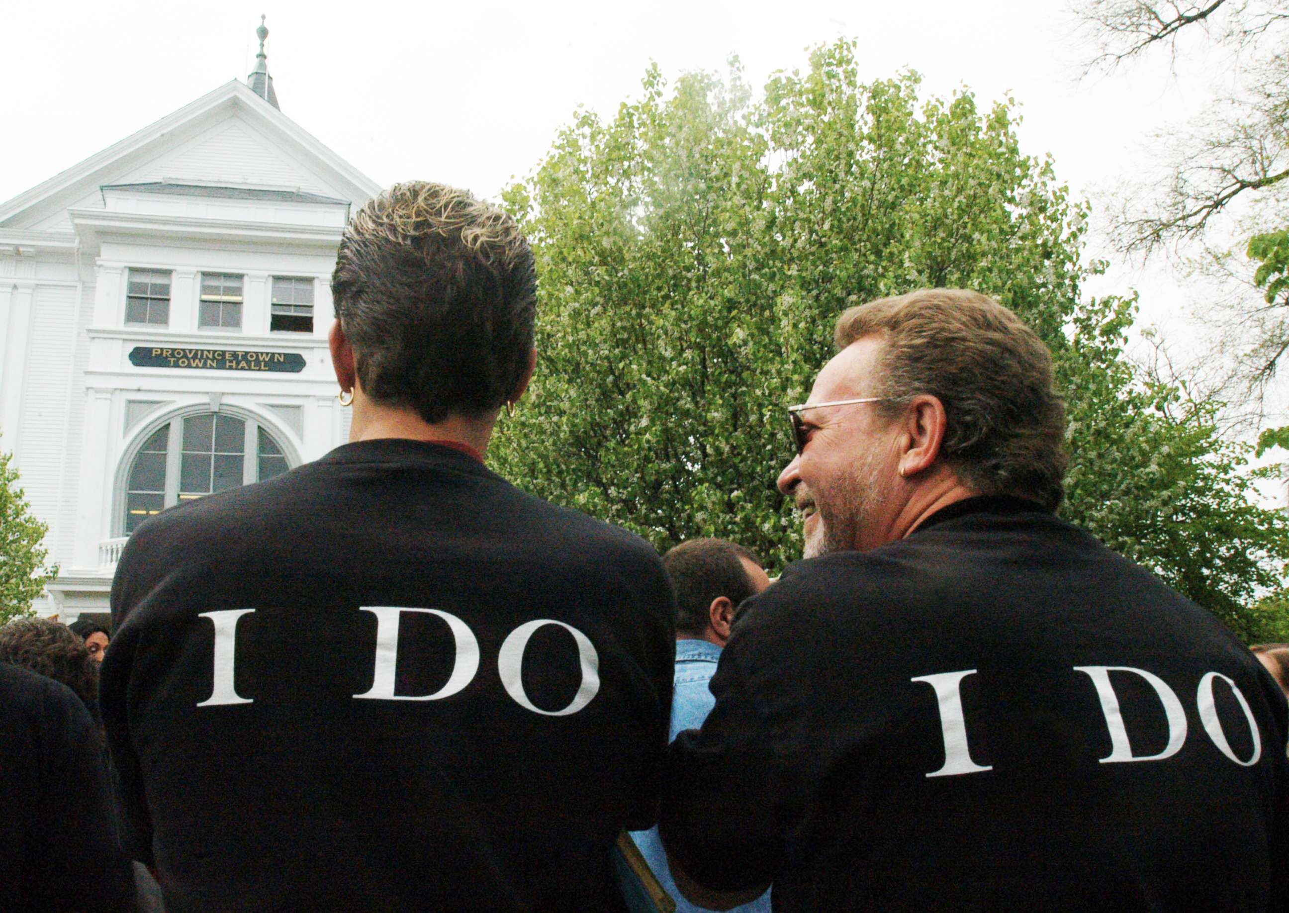 PHOTO: Two men wearing wait outside Town Hall, where same-sex couples from across the country gathered May 17, 2004, in Provincetown, Mass.