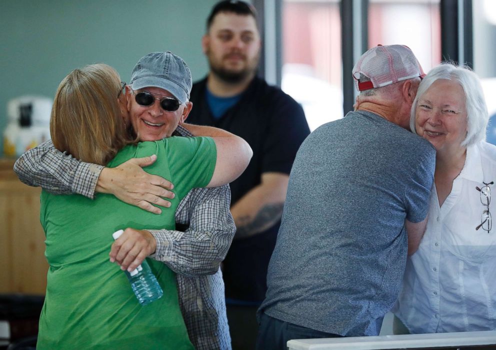 PHOTO: Supporters of baker Jack Phillips, owner of Masterpiece Cakeshop, hug inside Phillips' shop, June 4, 2018, in Lakewood, Colo.