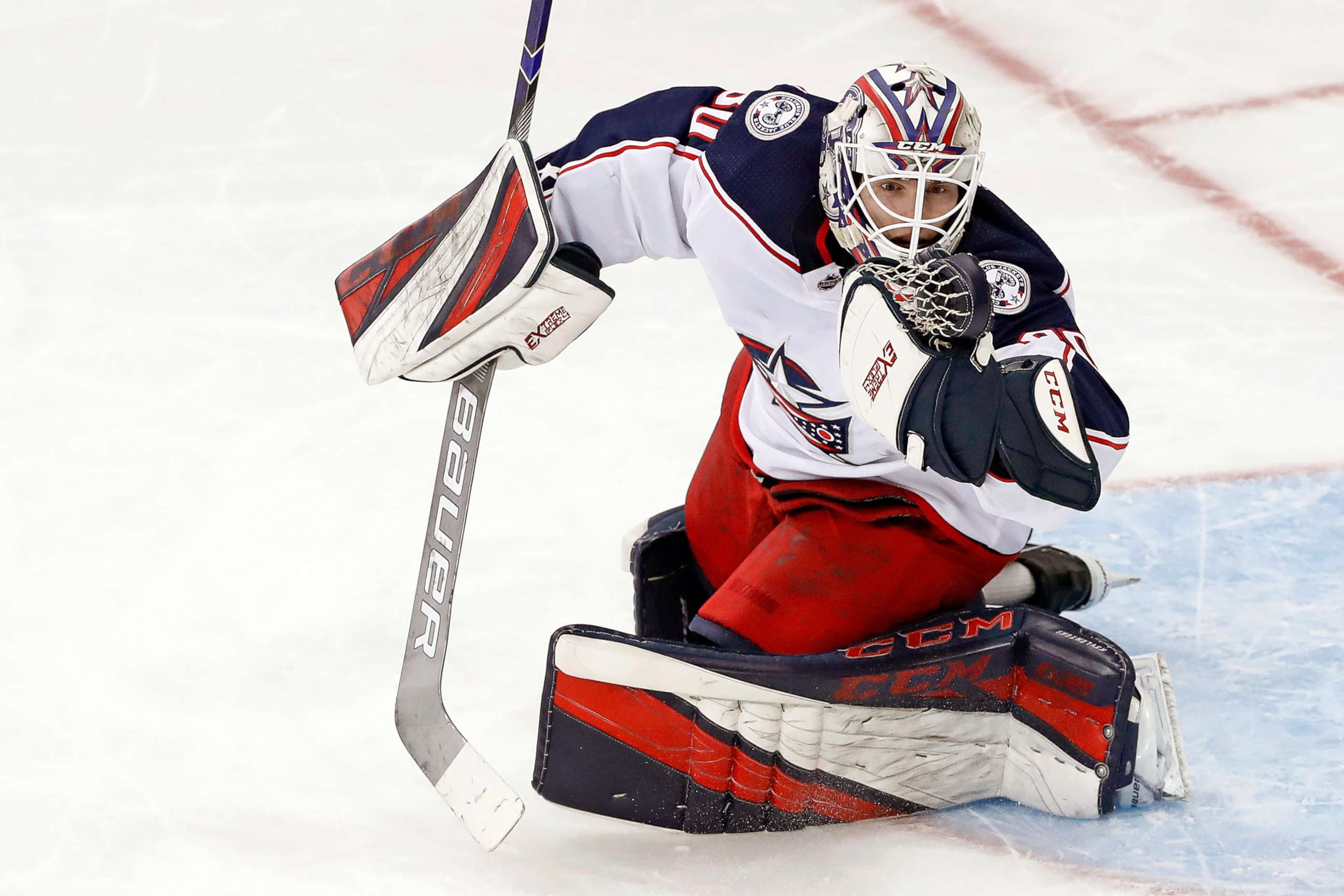 PHOTO: In this Jan. 19, 2020, file photo, Columbus Blue Jackets goaltender Matiss Kivlenieks has the puck in his hand as he makes a save during the third period of an NHL hockey game against the New York Rangers in New York.