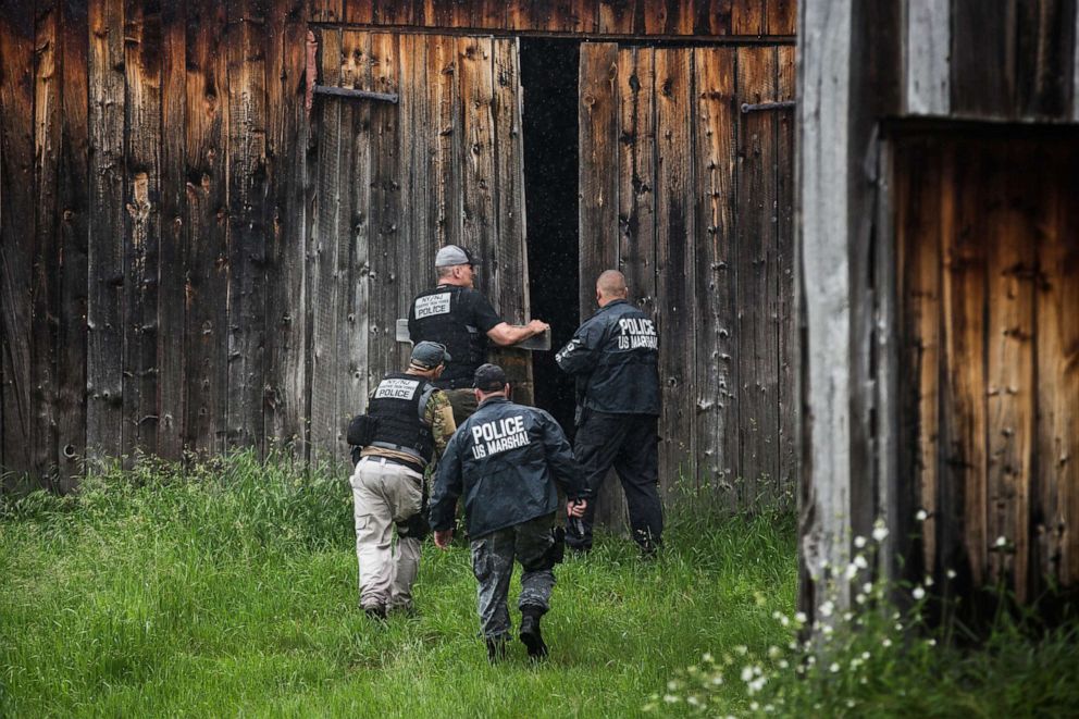 PHOTO: File photo: A task force of U.S. Marshalls and police officers go door to door searching for two escaped convicts on June 16, 2015 outside Dannemora, New York.