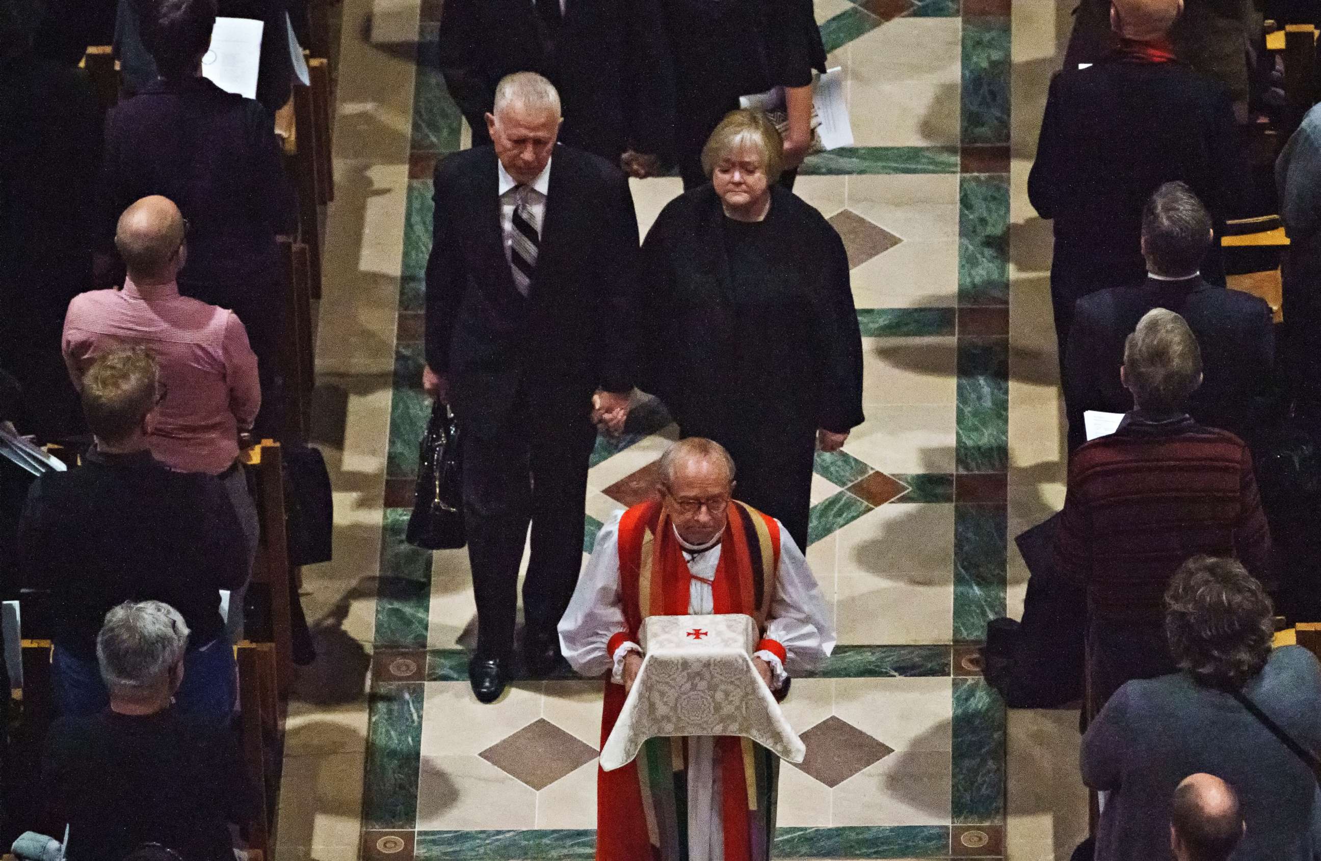 Dennis and Judy Shepard hold hands as they walk behind Rev. V. Gene Robinson carrying their son's ashes at the conclusion of a "Thanksgiving and Remembrance of Matthew Shepard" service at Washington National Cathedral in Washington, Oct. 26, 2018. 