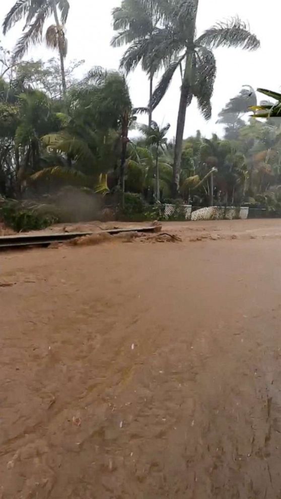 PHOTO: This still image taken from social media video shows a flooded road near the Kaupakalua Dam in Haiku on Maui, Hawaii, on March 8, 2021.