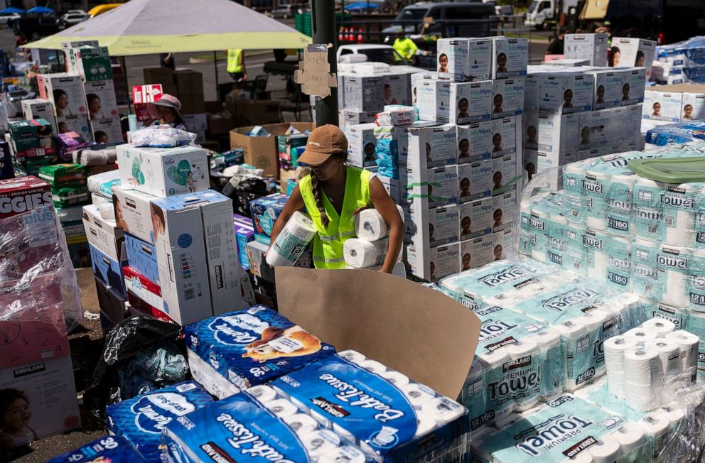 PHOTO: A volunteers works at a food and supply distribution center set up in the parking lot of a shopping mall in Lahaina, Hawaii, Aug. 16, 2023.