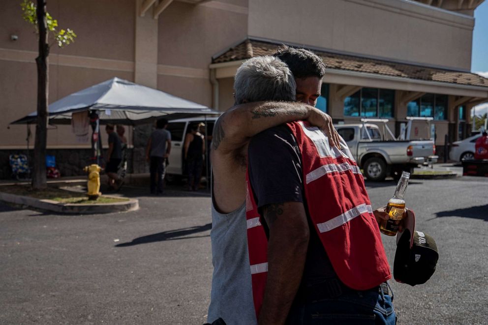 PHOTO: Keeaumoku Kapu hugs a community member at Lahaina Gateway Center in Lahaina, Hawaii on Aug. 13, 2023.