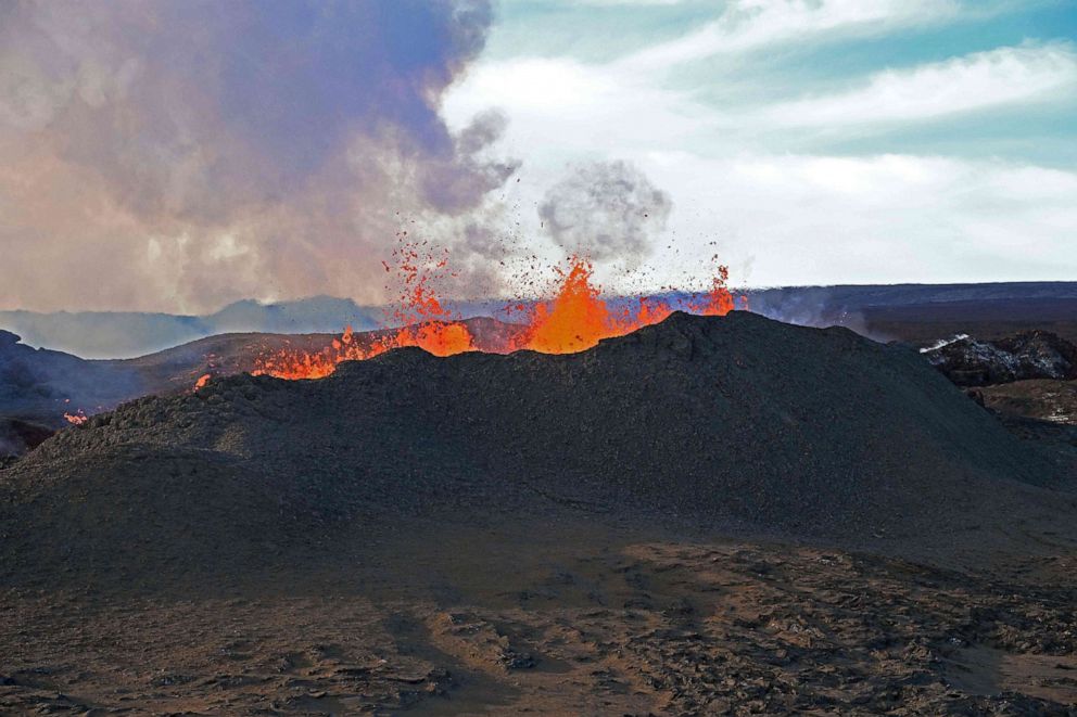 PHOTO: Spatter is seen being thrown from Fissure 3 on Mauna Loa's Northeast Rift Zone which has built the cone to a height of 95 feet and fed a lava flow that is 10.34 miles long near Hilo, Hawaii.