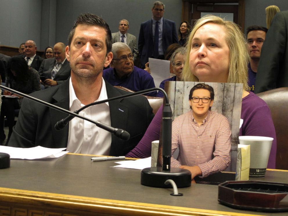 PHOTO: Stephen and Rae Ann Gruver sit in a House committee room behind a photo of their son, 18-year-old Maxwell Gruver, who died in what authorities say was a hazing incident, March 21, 2018, in Baton Rouge, La. 