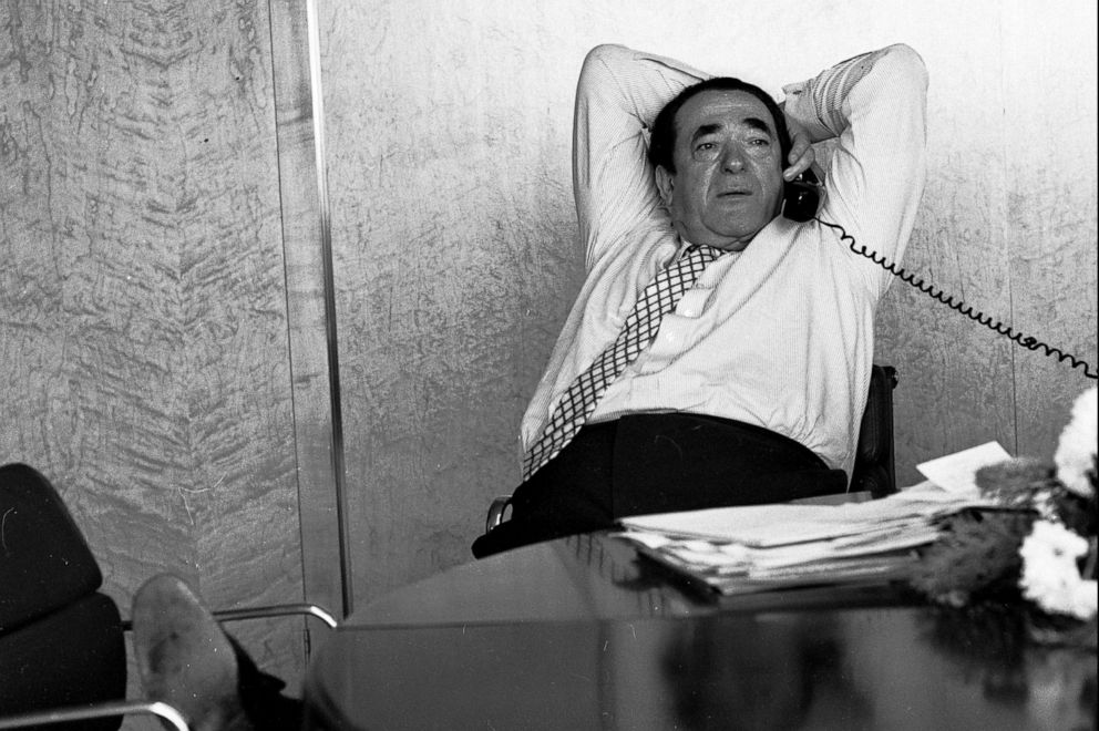 PHOTO: Robert Maxwell reclining at his desk while on the telephone, 1987. 