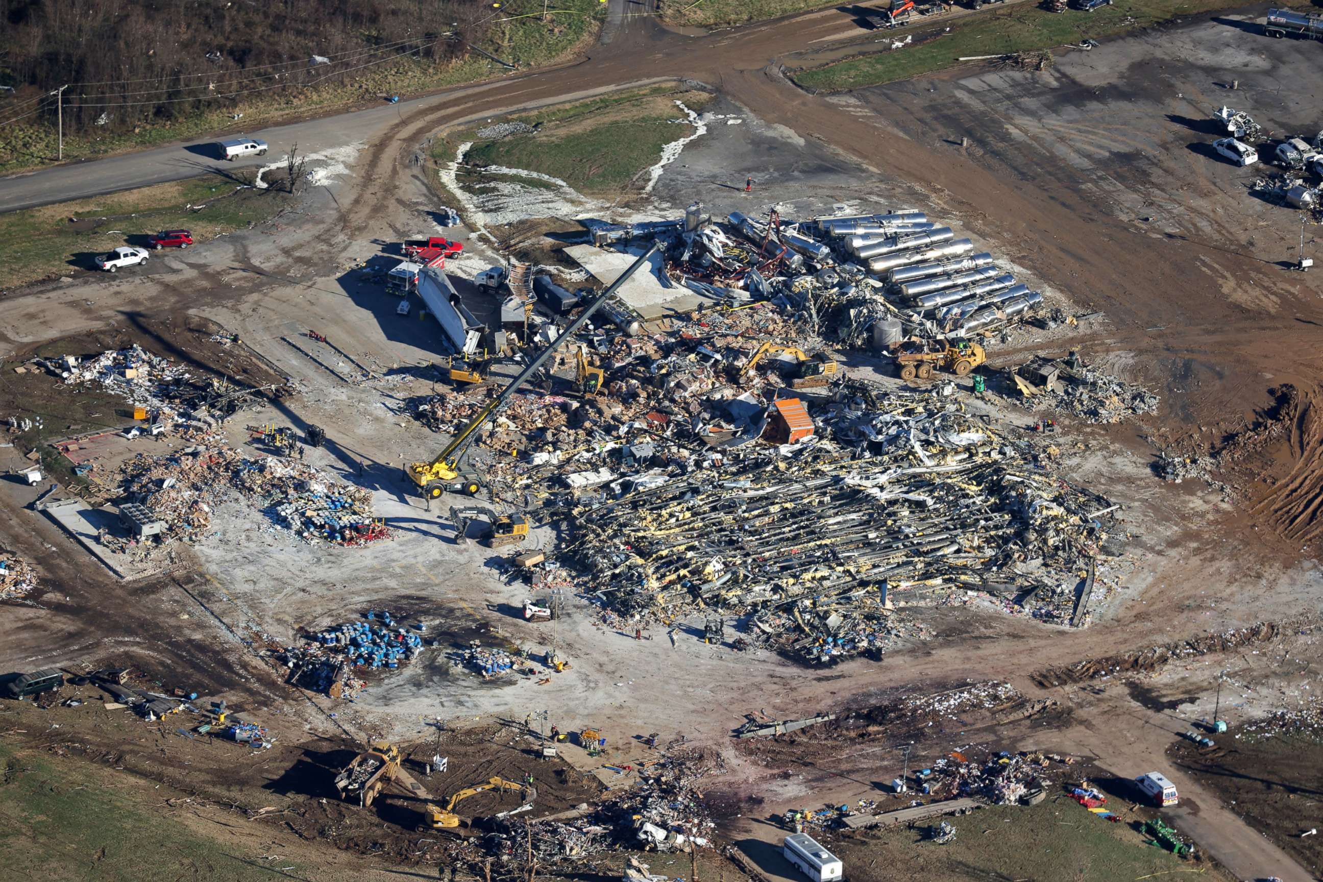 PHOTO: In this aerial view, crews clear the rubble at the Mayfield Consumer Products candle factory after it was destroyed by a tornado three days prior, on Dec. 13, 2021 in Mayfield, Ky.