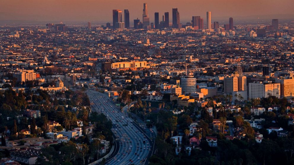View of Los Angeles at dusk taken from Beverly Hills, Mulholland Drive. The high rise offices of downtown are in the background, Hollywood in the foreground.