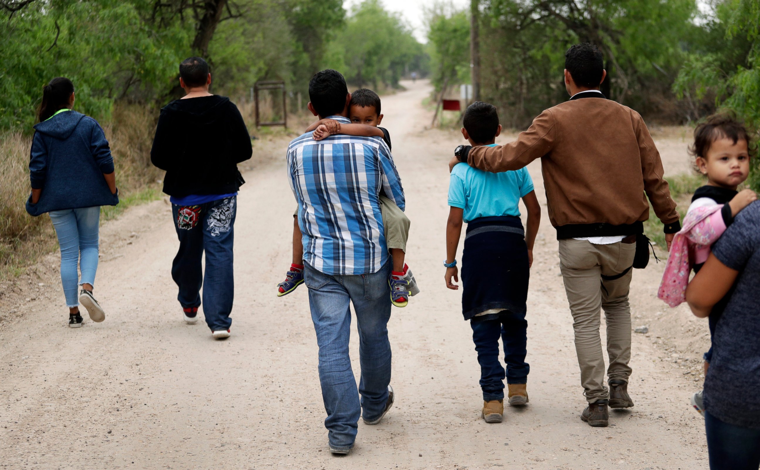 PHOTO: In this March 14, 2019, file photo, a group of migrant families walk from the Rio Grande, the river separating the U.S. and Mexico in Texas, near McAllen, Texas, right before being apprehended by Border Patrol.