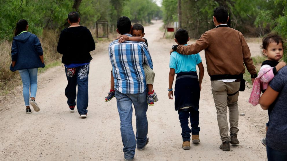 PHOTO: In this March 14, 2019, file photo, a group of migrant families walk from the Rio Grande, the river separating the U.S. and Mexico in Texas, near McAllen, Texas, right before being apprehended by Border Patrol.