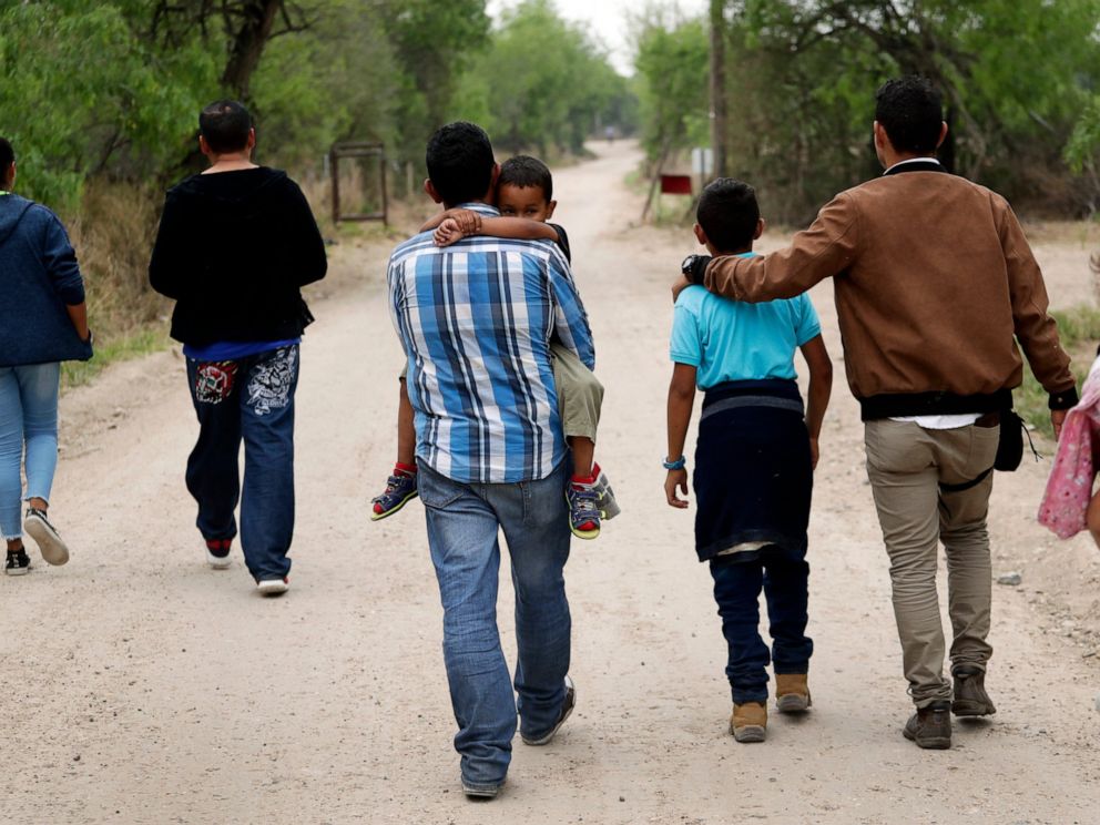 PHOTO: In this March 14, 2019, file photo, a group of migrant families walk from the Rio Grande, the river separating the U.S. and Mexico in Texas, near McAllen, Texas, right before being apprehended by Border Patrol.