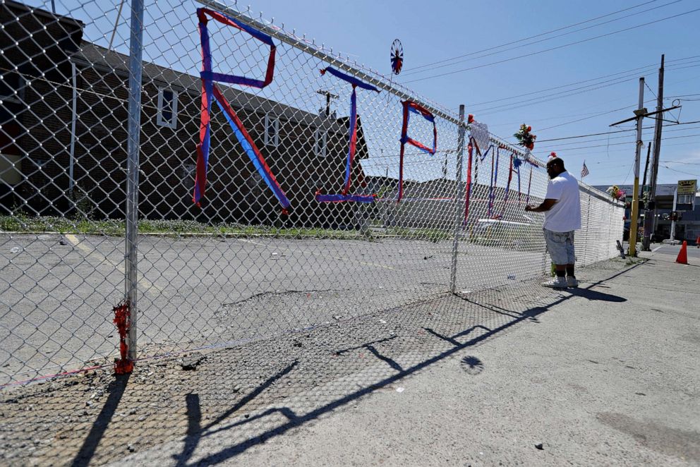 PHOTO: Dwayne Simmons makes a memorial to David McAtee near the intersection of 26th and Broadway, June 2, 2020, in Louisville, Ky.