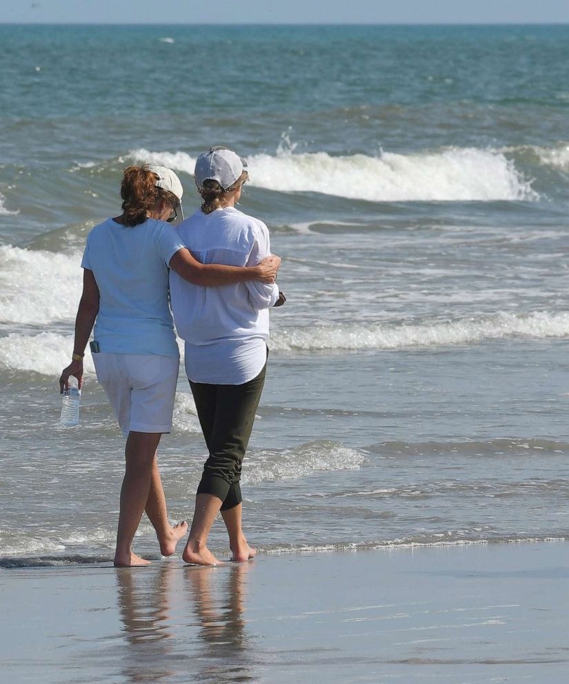 PHOTO: A friend comforts Stephanie Young McCluney, right, wife of Brian McCluney, one of two missing boaters, at Jetty Park, Port Canaveral, Fla., Aug. 18, 2019.