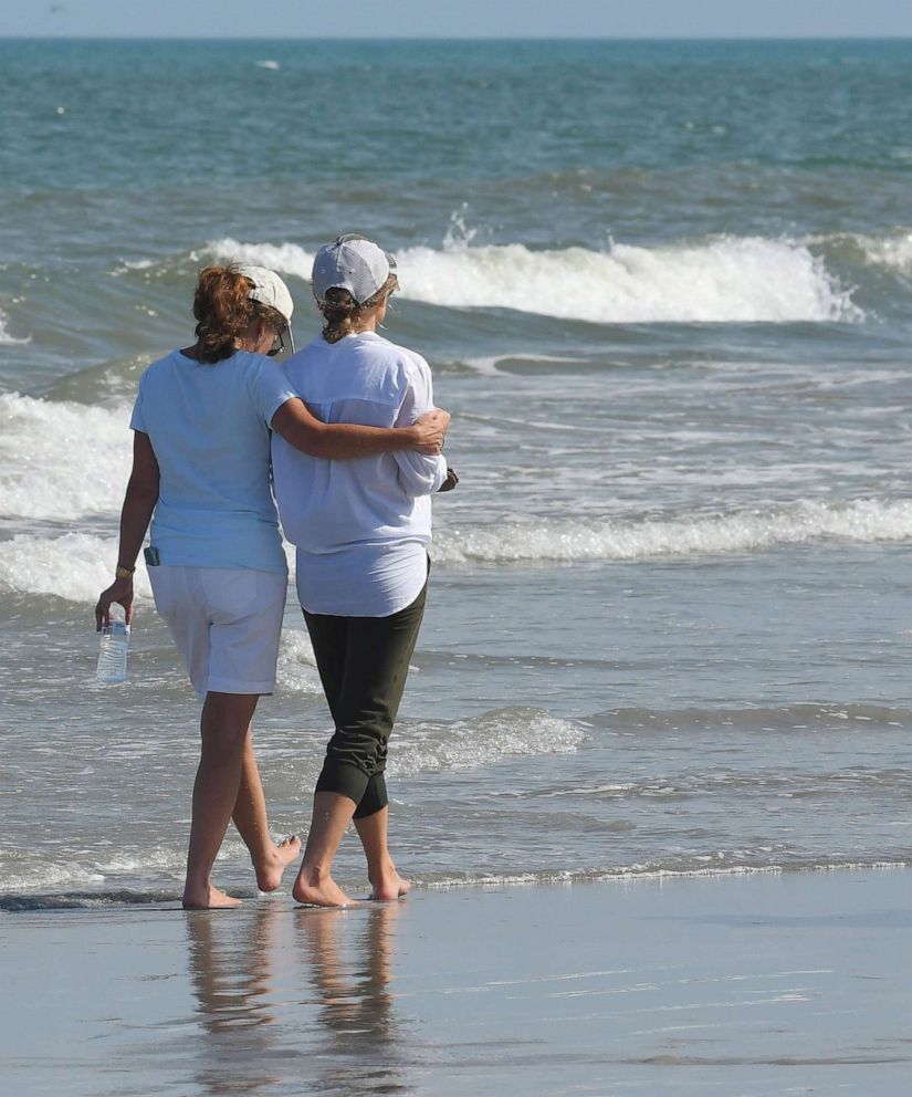 PHOTO: A friend comforts Stephanie Young McCluney, right, wife of Brian McCluney, one of two missing boaters, at Jetty Park, Port Canaveral, Florida on August 18, 2019.