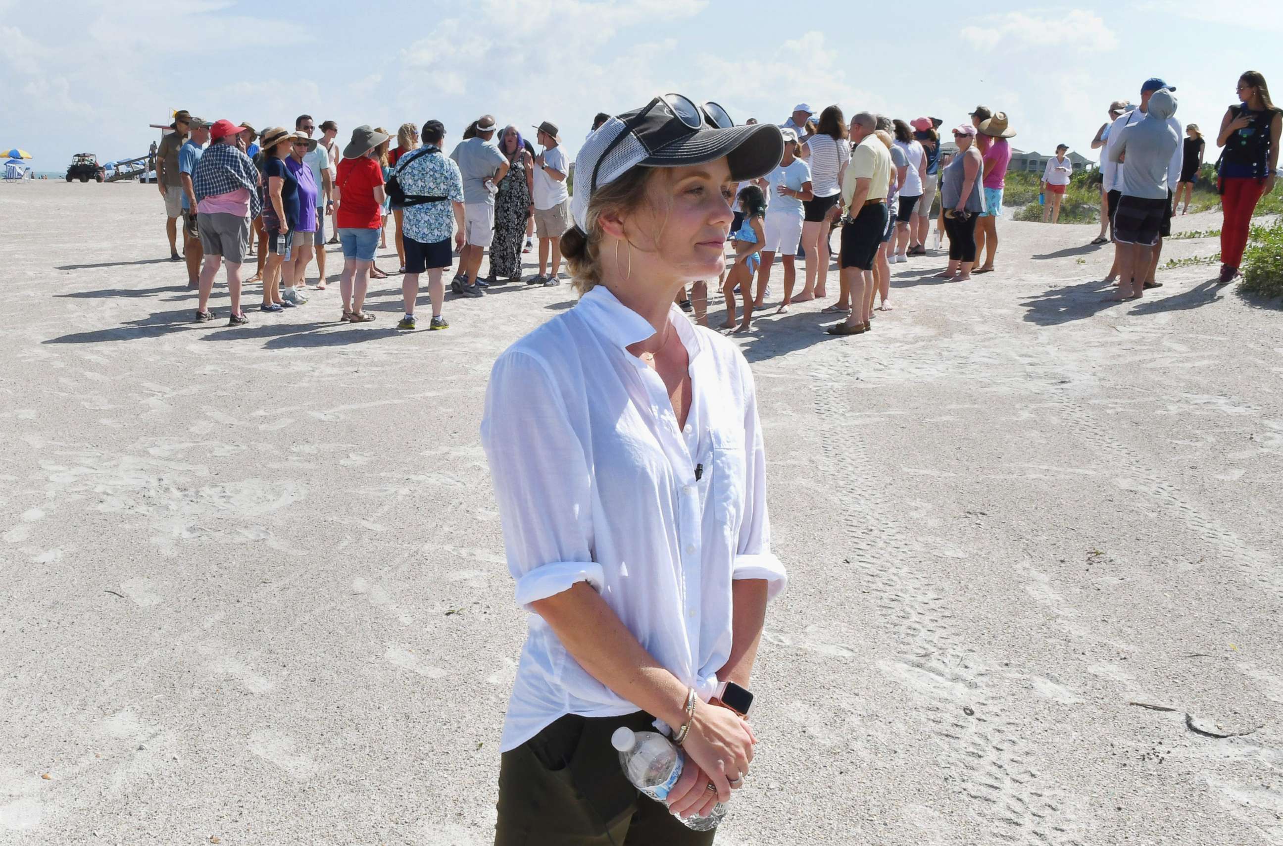 PHOTO: Stephanie Young McCluney, wife of Brian McCluney, one of two missing boaters, is joined by supporters at Jetty Park, Aug. 18, 2019, to pray and search the shore clues to the missing boaters who left Port Canaveral two days earlier.