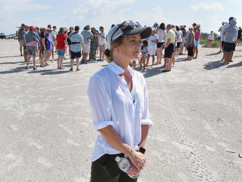 PHOTO: Stephanie Young McCluney, wife of Brian McCluney, one of two missing boaters, is accompanied by supporters to Jetty Park on August 18, 2019, to pray and search for clues about missing sailors who have left Port Canaveral two days earlier.