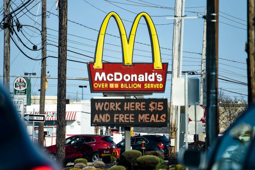 PHOTO: A sign at the McDonald's restaurant in Sinking Spring, Pa., reads, "Work here $15 and free meals," April 8, 2021.