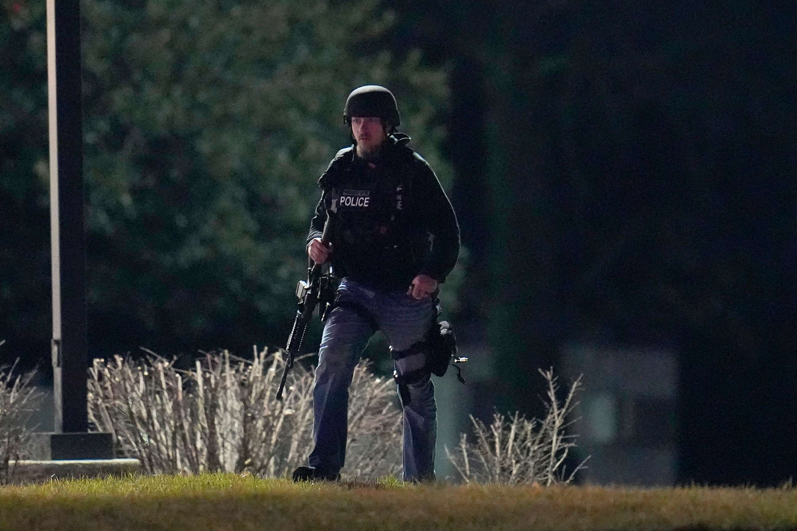 PHOTO: An official walks near a wooded area during a search for a gunman on Feb. 10, 2023, in Fallston, Md.