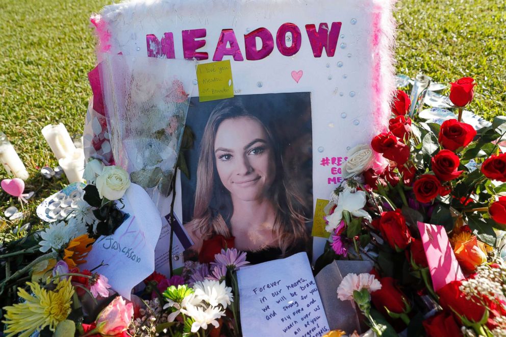 PHOTO: A photo of Meadow Pollack, one of the seventeen victims who was killed in the shooting at Marjory Stoneman Douglas High School, sits against a cross as part of a public memorial, in Parkland, Fla., Feb. 17, 2018.