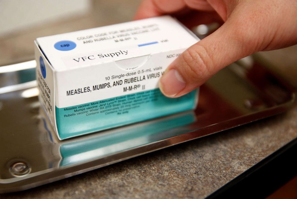 PHOTO: A medical assistant holds a box of measles, mumps, and rubella (MMR) vaccine vials at the International Community Health Services clinic in Seattle, March 20, 2019.  